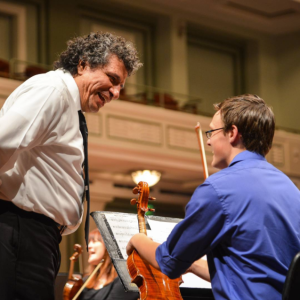 Music Director Giancarlo Guerrero works with a student during Side-by-Concert rehearsals, May 20, 2015